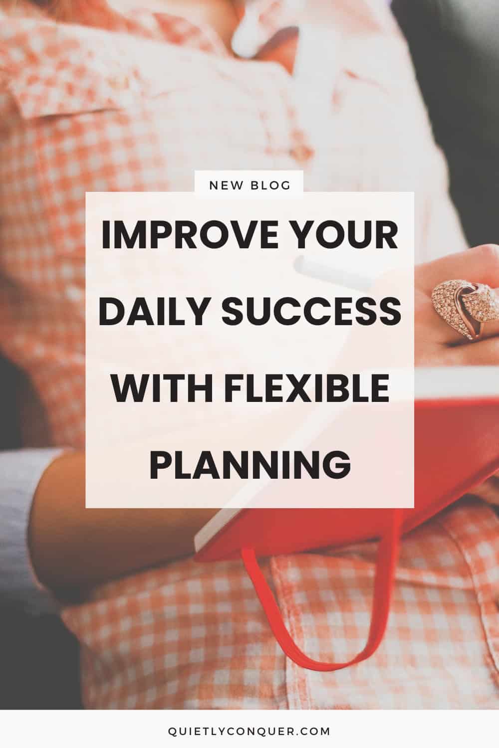 A woman in orange dress sat writing in planner