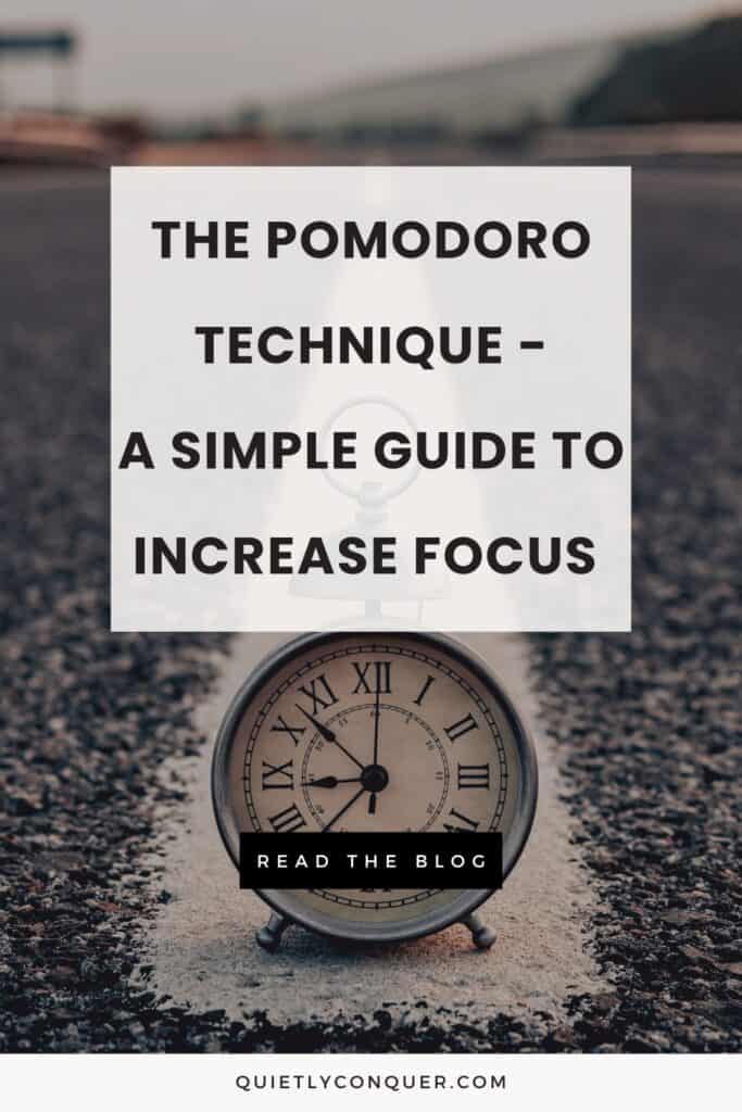 An analogue clock in the middle of a road. The txt in front reads - The Pomodoro Technique - A Simple Guide To Increase Focus